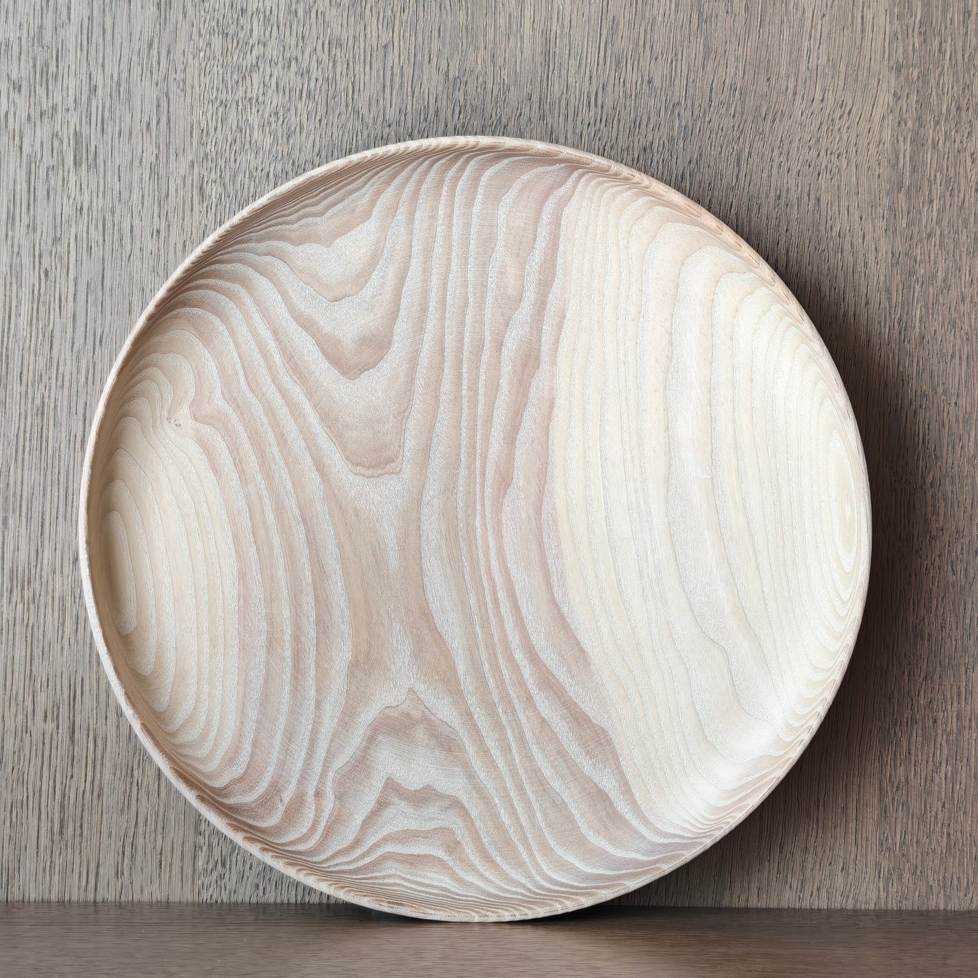 Round wooden plate with wood pattern on a wooden surface