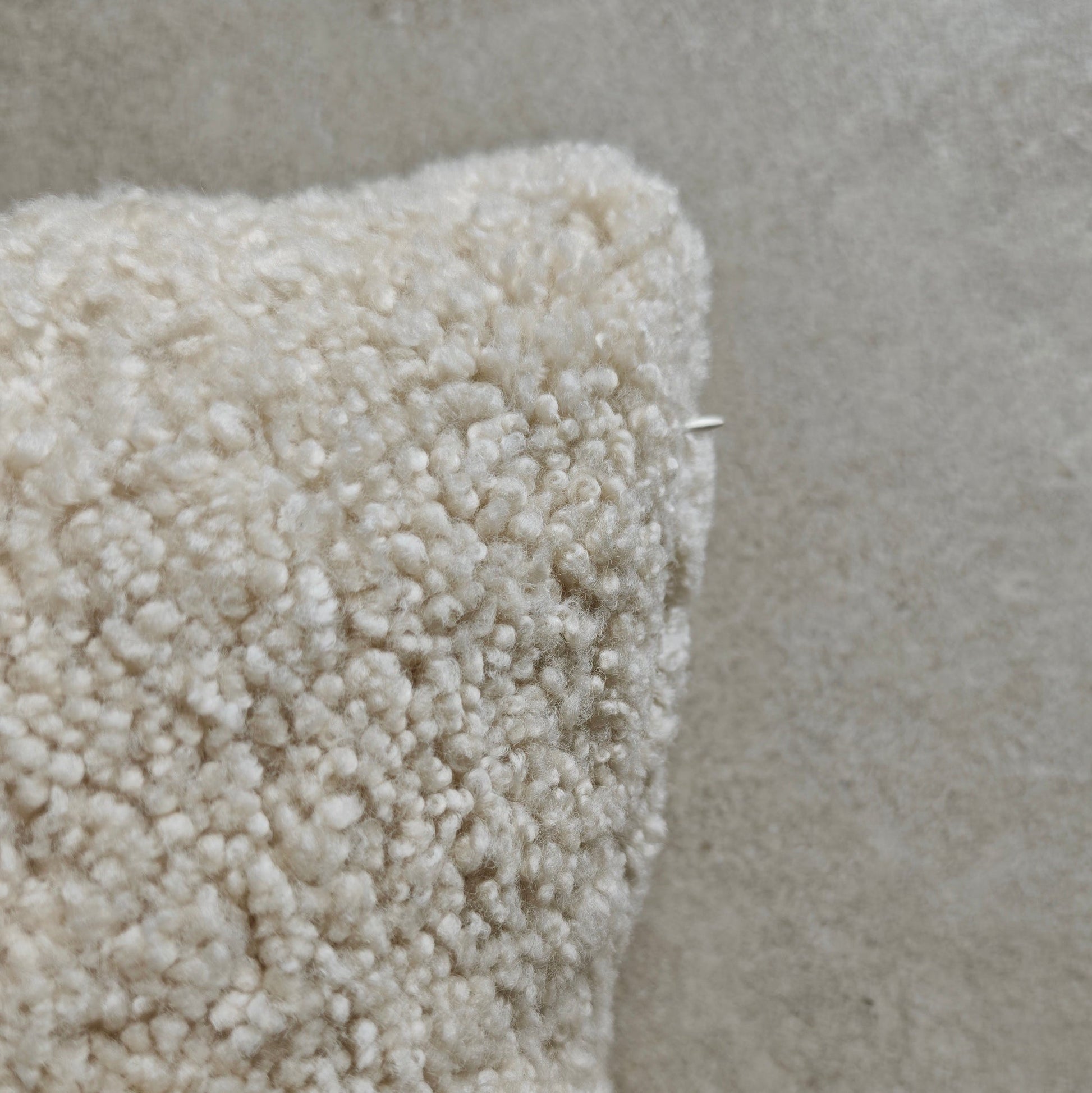 Close-up of a textured beige Buri sheepskin cushion